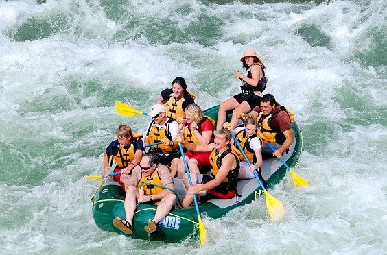 A group of rafters riding rapids on the Snake River in Jackson Hole