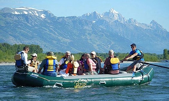 A raft guide paddles down a calm stretch of the Snake River