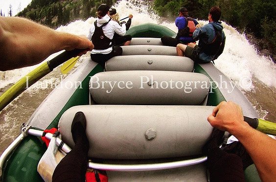 A POV shot of a rafting guide crashing into a rapid while rafting in Jackson Hole