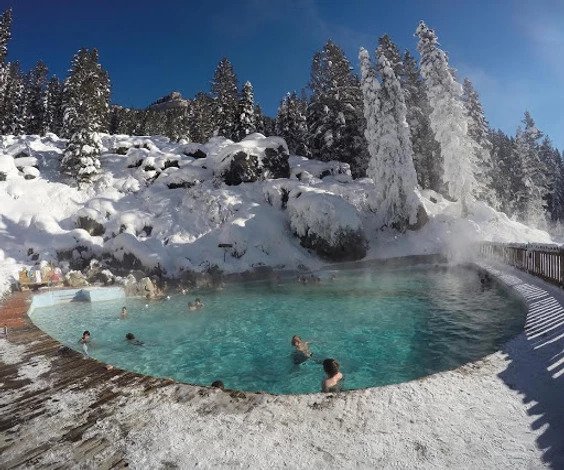 A group of people swim in a hot spring in Jackson Hole