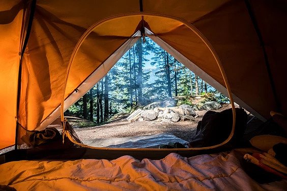 A shot of a campsite from the perspective of being inside a tent