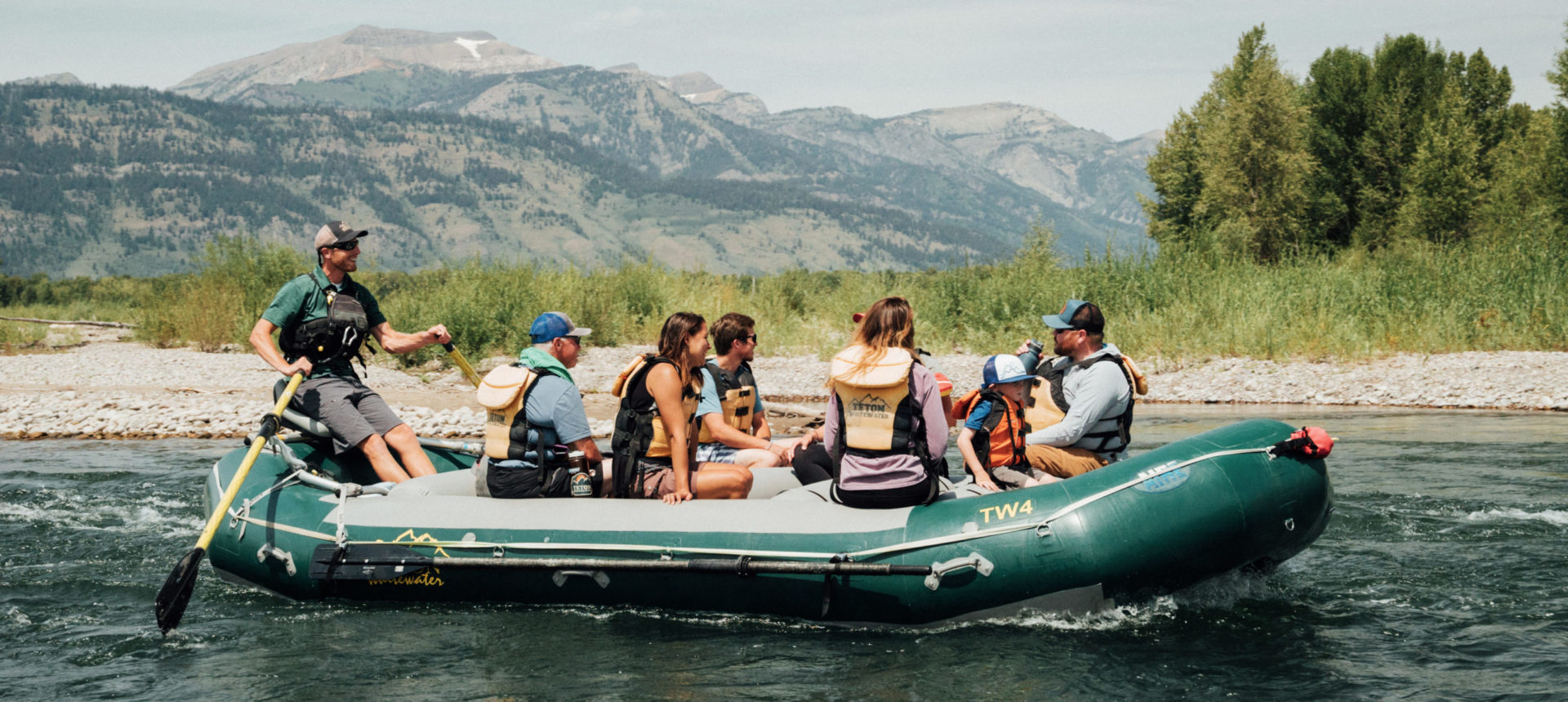 A raft guide paddles down a calm stretch of the Snake River