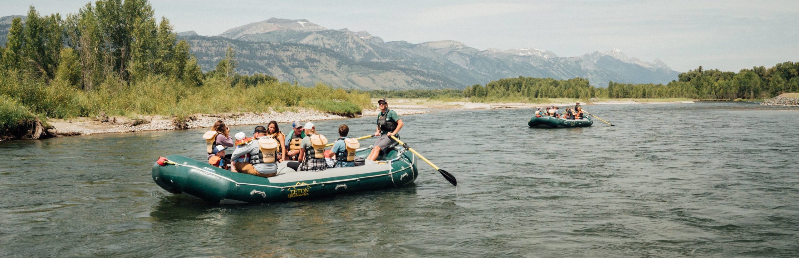 Two rafts float on the Snake River